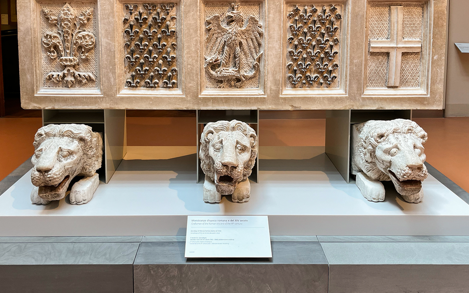 Stone lion sculptures and ornate carvings at Florence Duomo museum exhibit.