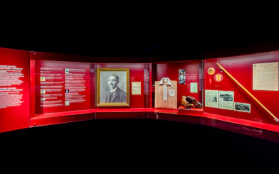 Benfica Stadium museum exhibit featuring Cosme Damião memorabilia and historical artifacts.