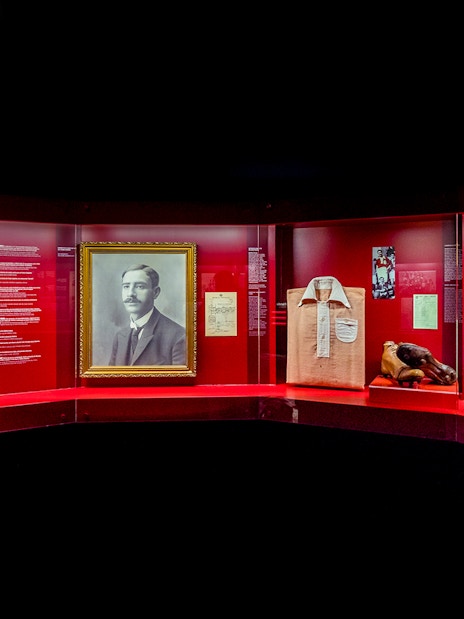 Benfica Stadium museum exhibit featuring Cosme Damião memorabilia and historical artifacts.