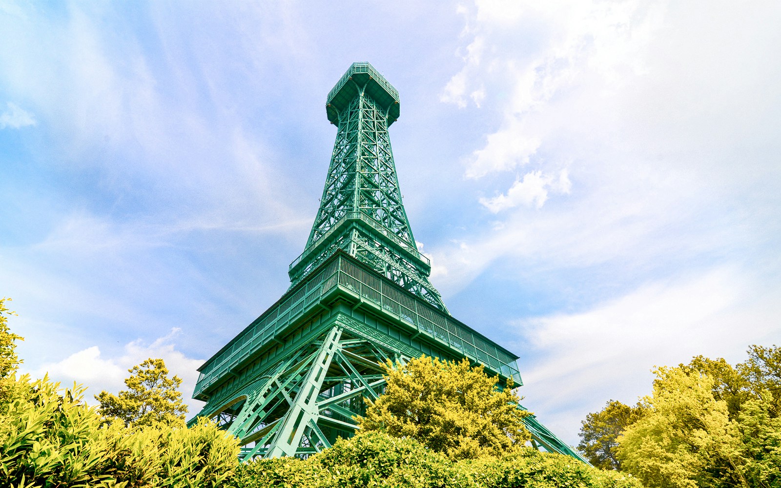 Replica Eiffel Tower at Six Flags King's Dominion surrounded by trees.
