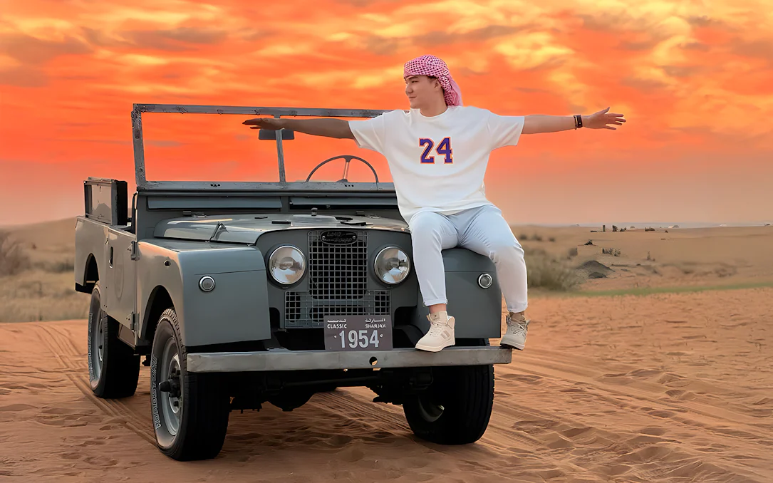 Vintage Land Rover in desert at sunset, part of hot air balloon experience.