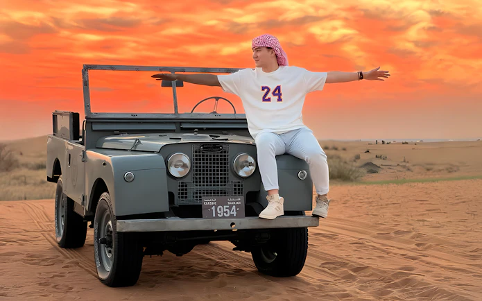 Vintage Land Rover in desert at sunset, part of hot air balloon experience.