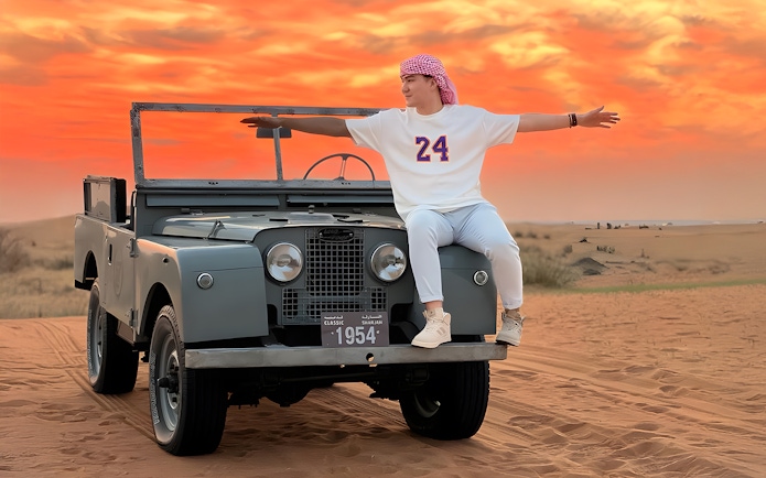 Vintage Land Rover in desert at sunset, part of hot air balloon experience.