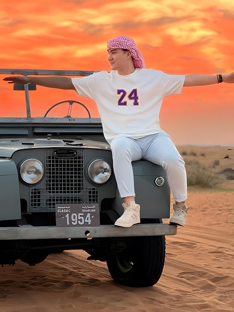 Vintage Land Rover in desert at sunset, part of hot air balloon experience.
