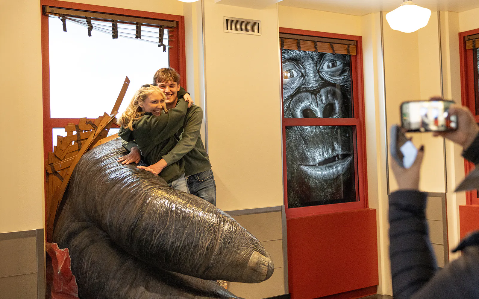 Couple posing with King Kong exhibit at Empire State Building.