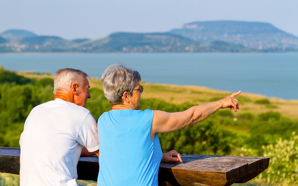 Guests admiring Lake Balaton from a scenic viewpoint.