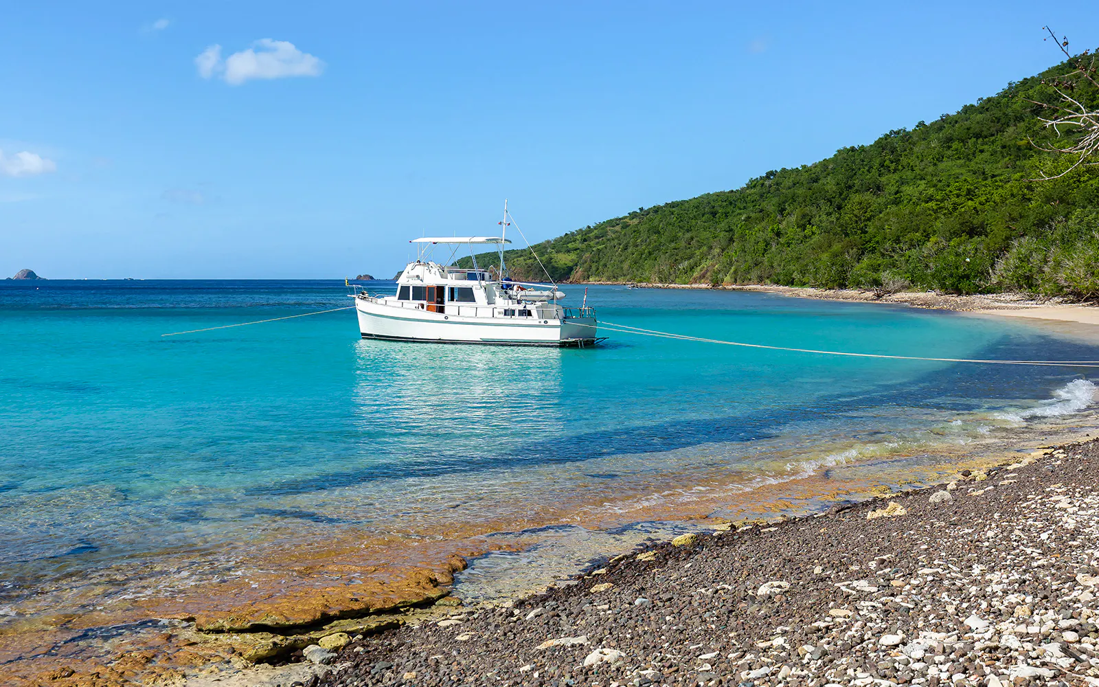 Private boat cruising near coastal city skyline