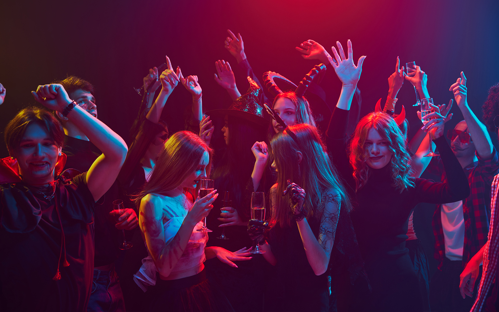 Young people in costumes celebrating Halloween at a nightclub in Las Vegas.