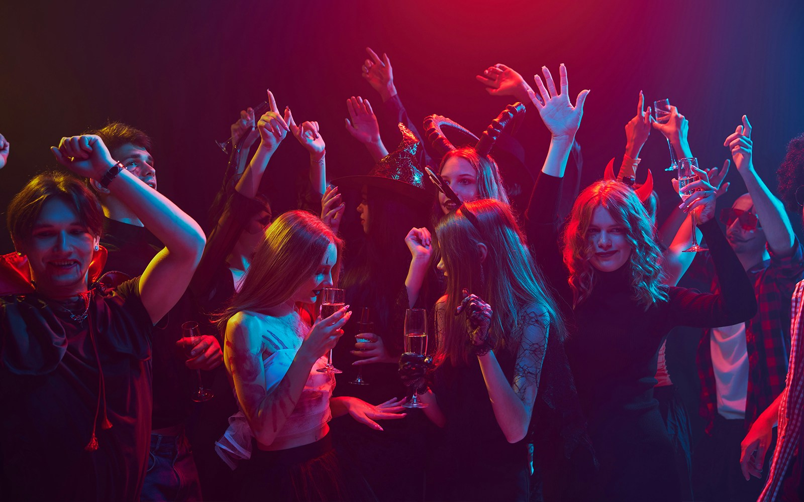 Young people in costumes celebrating Halloween at a nightclub in Las Vegas.