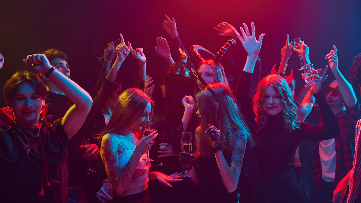Young people in costumes celebrating Halloween at a nightclub in Las Vegas.