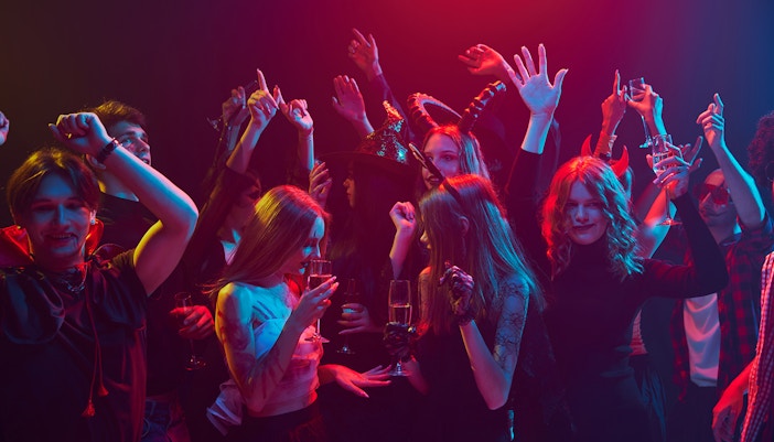 Young people in costumes celebrating Halloween at a nightclub in Las Vegas.