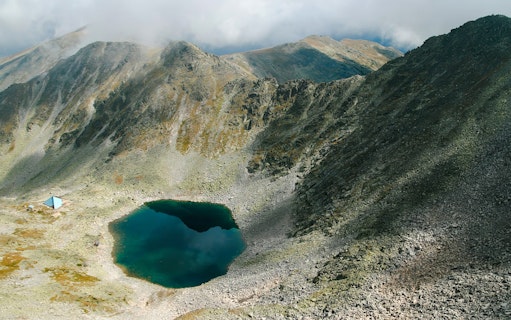 Glacial lake surrounded by rocky mountains on the route to Musala Peak, Bulgaria.