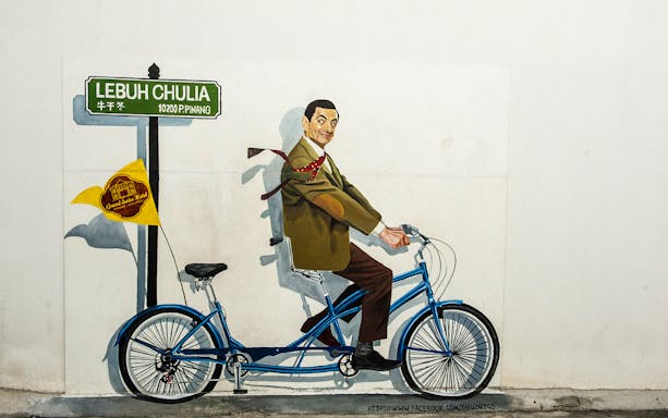 Street art of a man on a tandem bicycle at Lebuh Chulia, Penang.