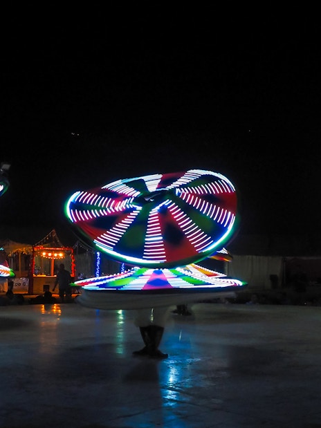 Tanoura dancers performing with illuminated skirts in Dubai.