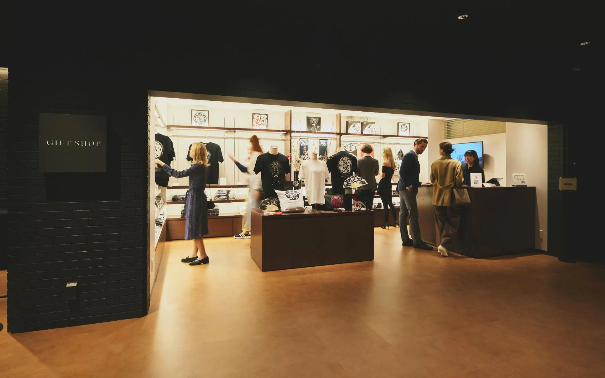 Gift shop at DRUM TAO Theater Kyoto with visitors browsing merchandise.