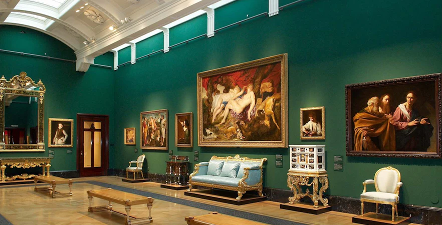 King's Gallery at Buckingham Palace featuring classic paintings and ornate furniture.