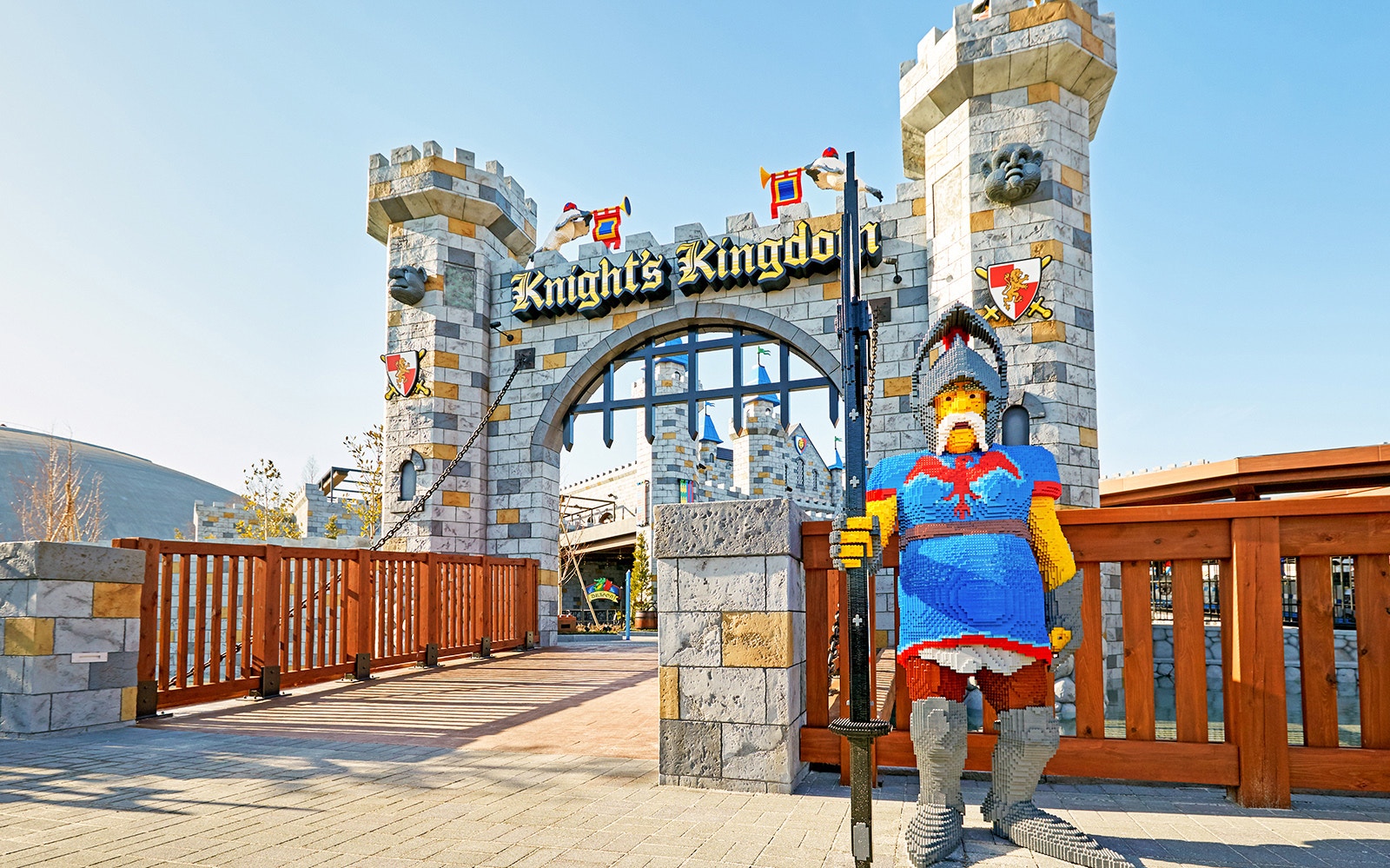 Children enjoying rides at Legoland Japan with colorful Lego structures in the background.