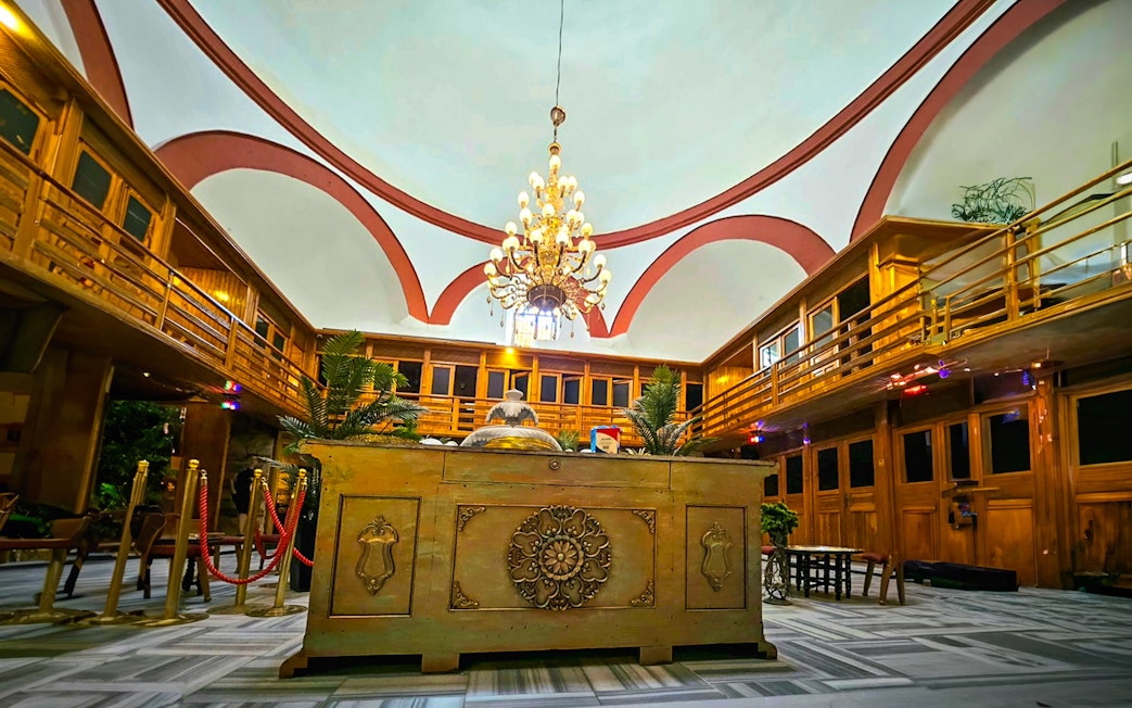 Interior view of Gedikpasa Historical Hammam with ornate chandelier and wooden decor.