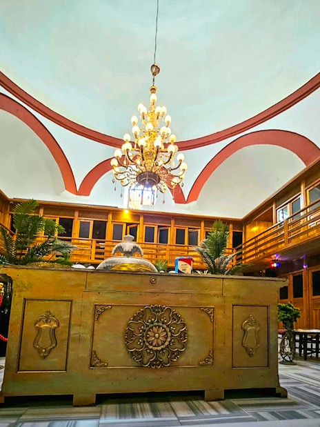 Interior view of Gedikpasa Historical Hammam with ornate chandelier and wooden decor.