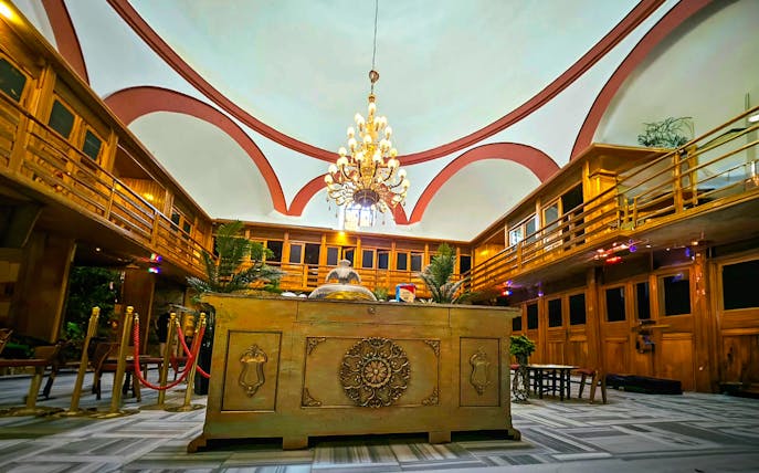 Interior view of Gedikpasa Historical Hammam with ornate chandelier and wooden decor.