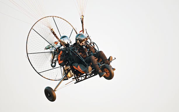Tandem paramotor flight during adventure tour.
