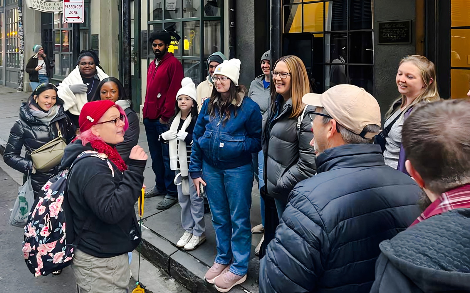 Tour group gathered for New Orleans Haunted Ghost, Voodoo & Vampire Tour outside a historical building.