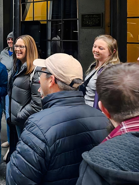Tour group gathered for New Orleans Haunted Ghost, Voodoo & Vampire Tour outside a historical building.