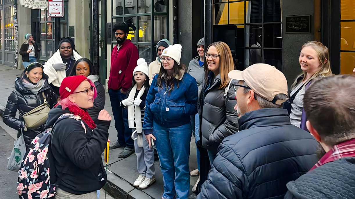 Tour group gathered for New Orleans Haunted Ghost, Voodoo & Vampire Tour outside a historical building.