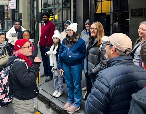 Guided tour group exploring New Orleans haunted sites, featuring ghost, voodoo, and vampire stories.