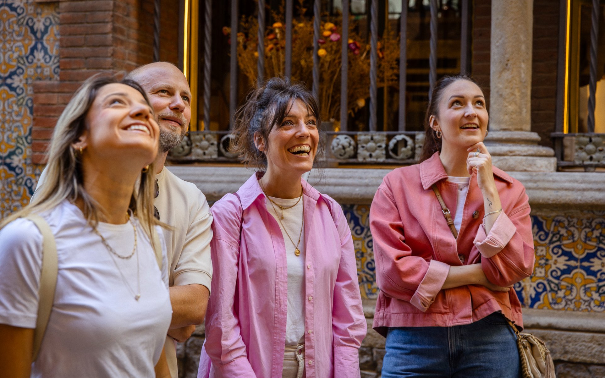 Tourists enjoying a guided walking tour in Barcelona, admiring architectural details.