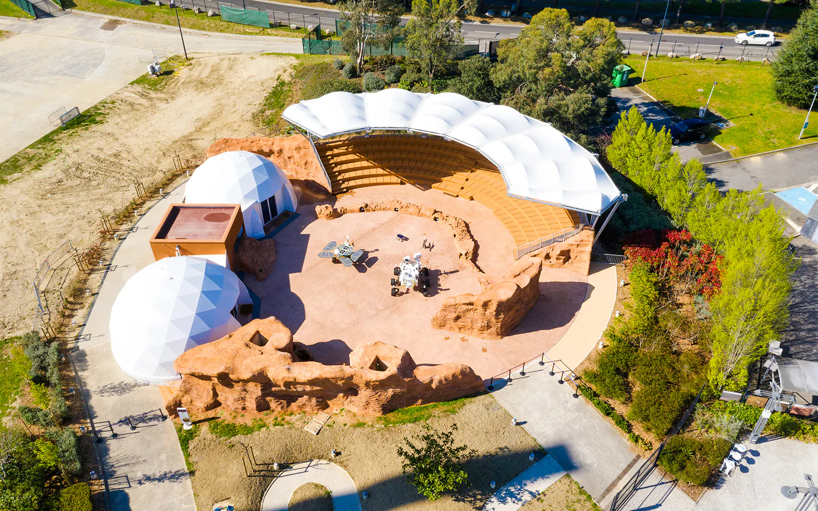 Aerial view of Mars-themed exhibit at Cité de l’Espace, France, featuring geodesic domes and amphitheater.