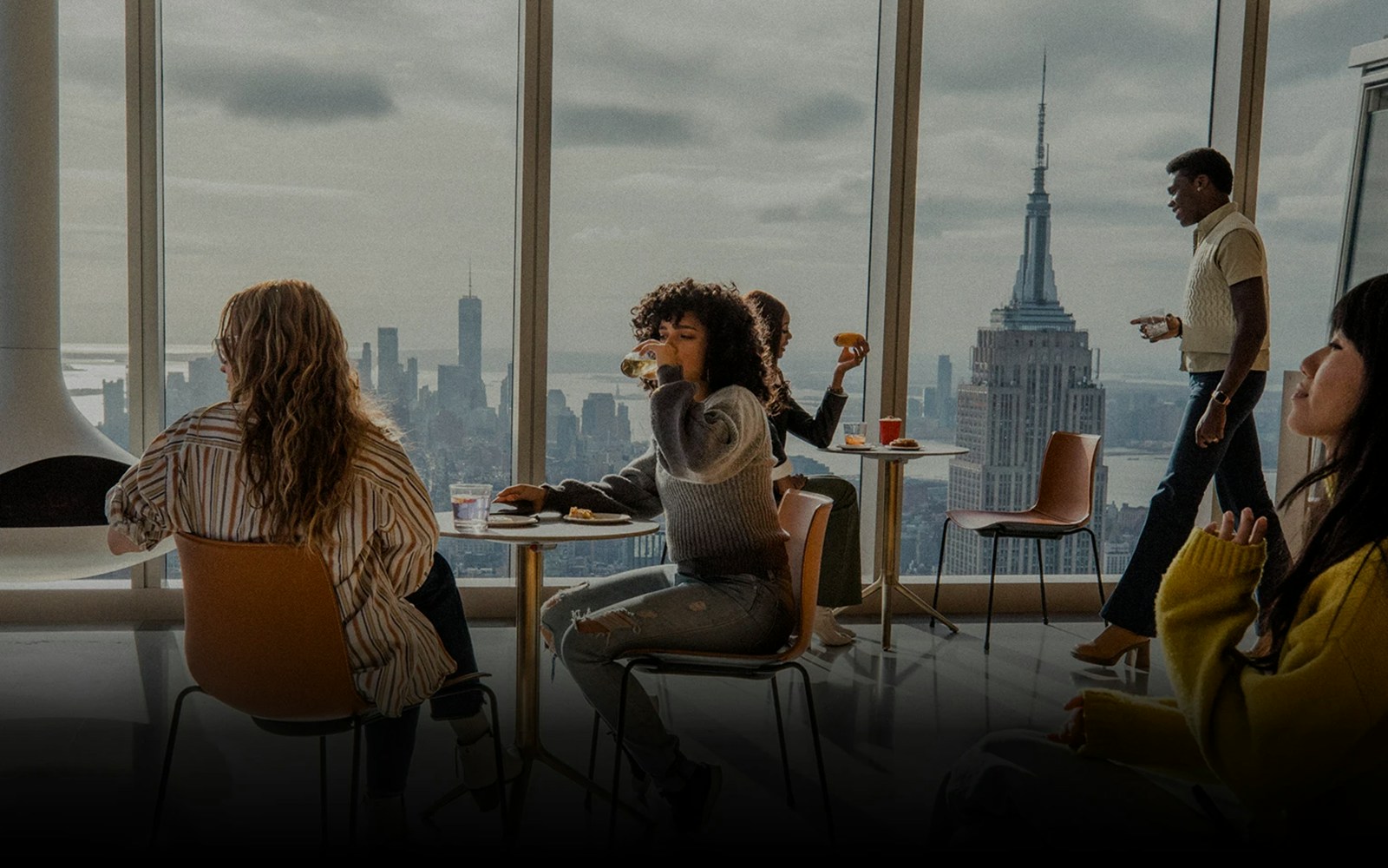 Visitors enjoying the panoramic view from SUMMIT One Vanderbilt's APRÈS lounge in New York City.