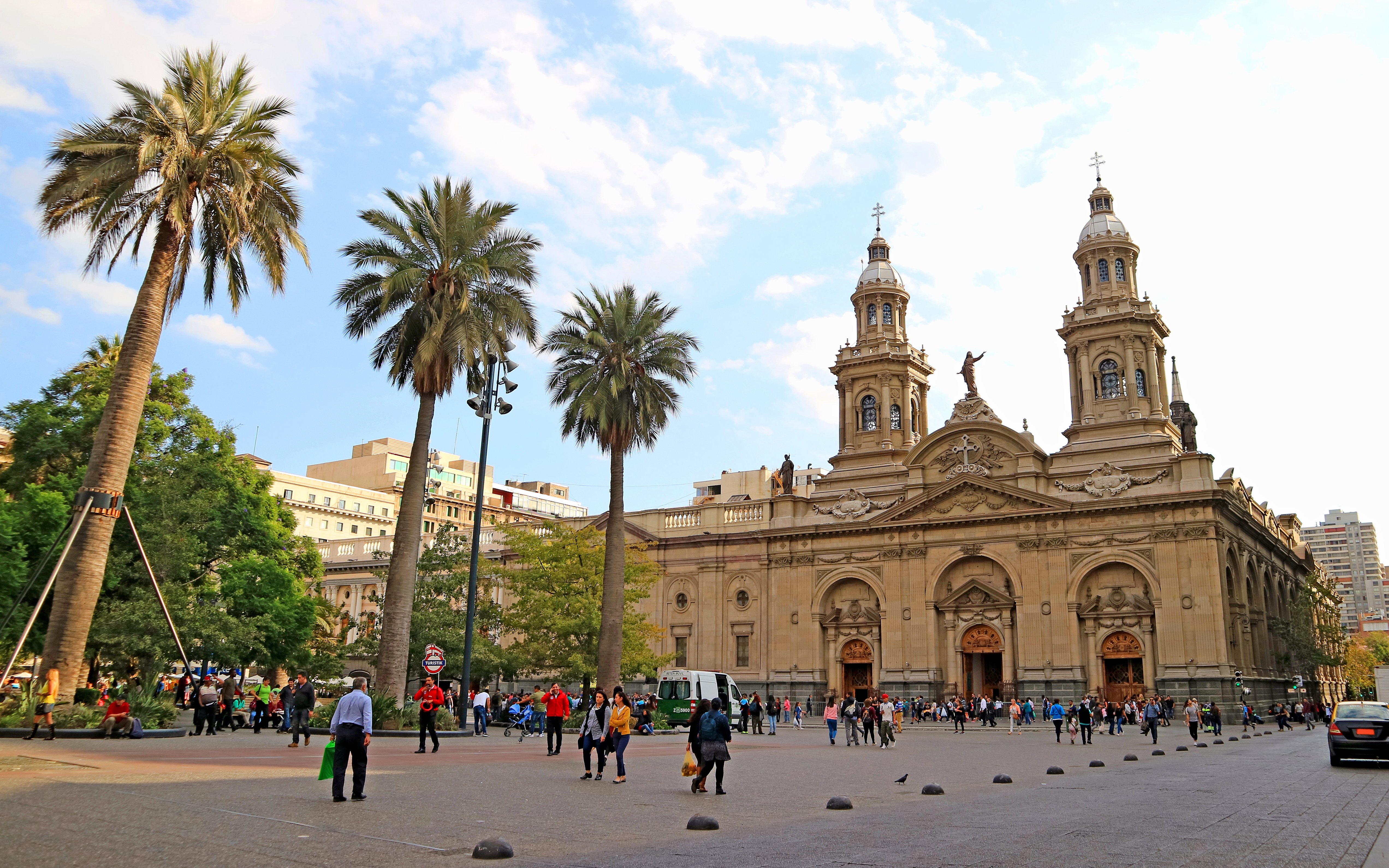 Plaza de Armas Square in Santiago with people walking near the Metropolitan Cathedral.