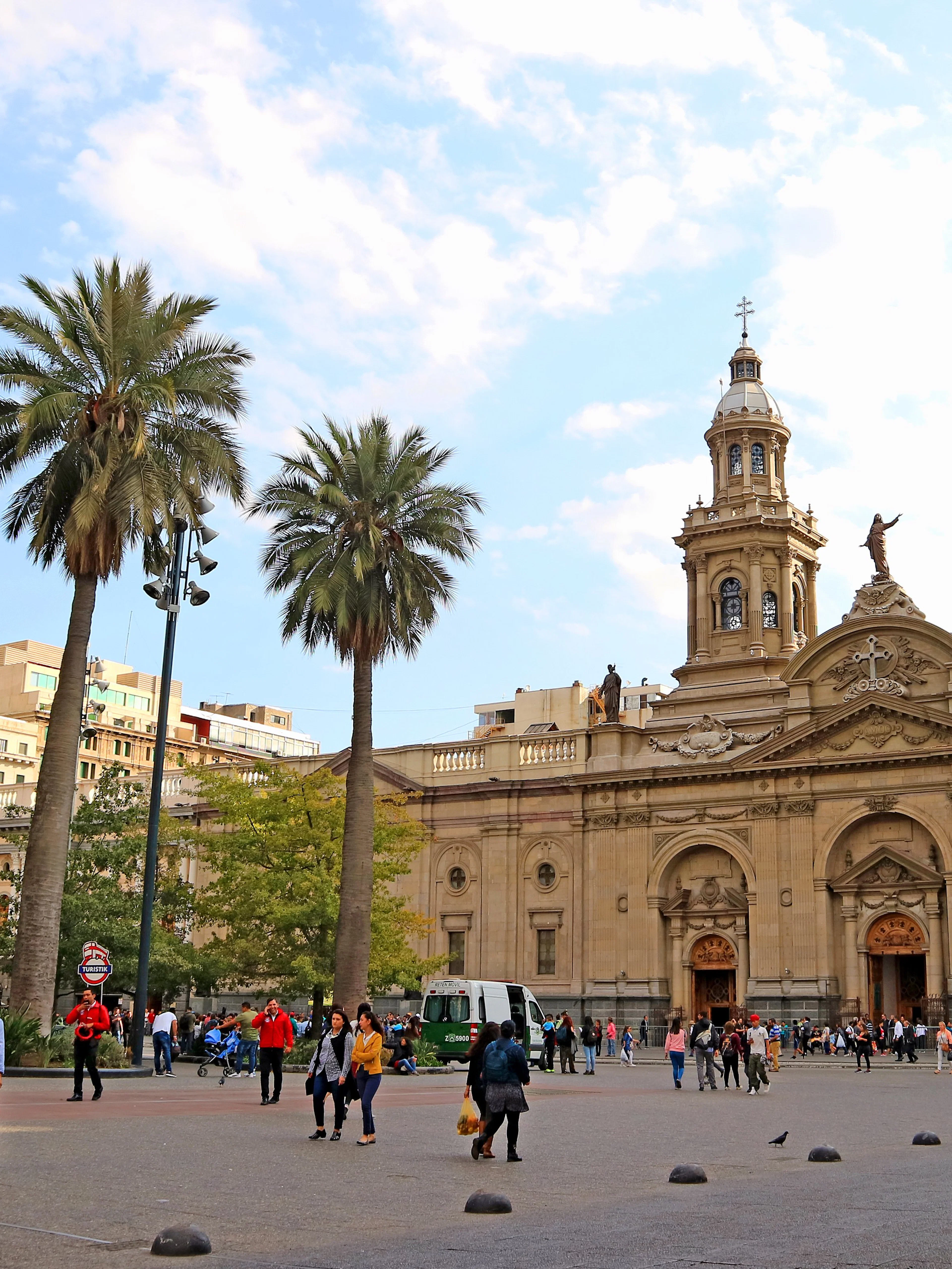Plaza de Armas Square in Santiago with people walking near the Metropolitan Cathedral.