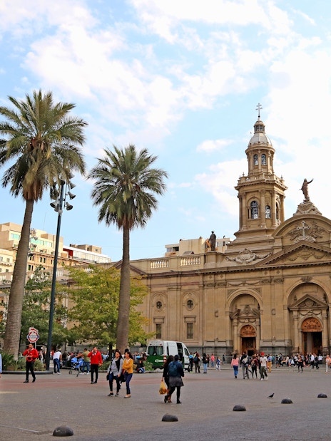 Plaza de Armas Square in Santiago with people walking near the Metropolitan Cathedral.