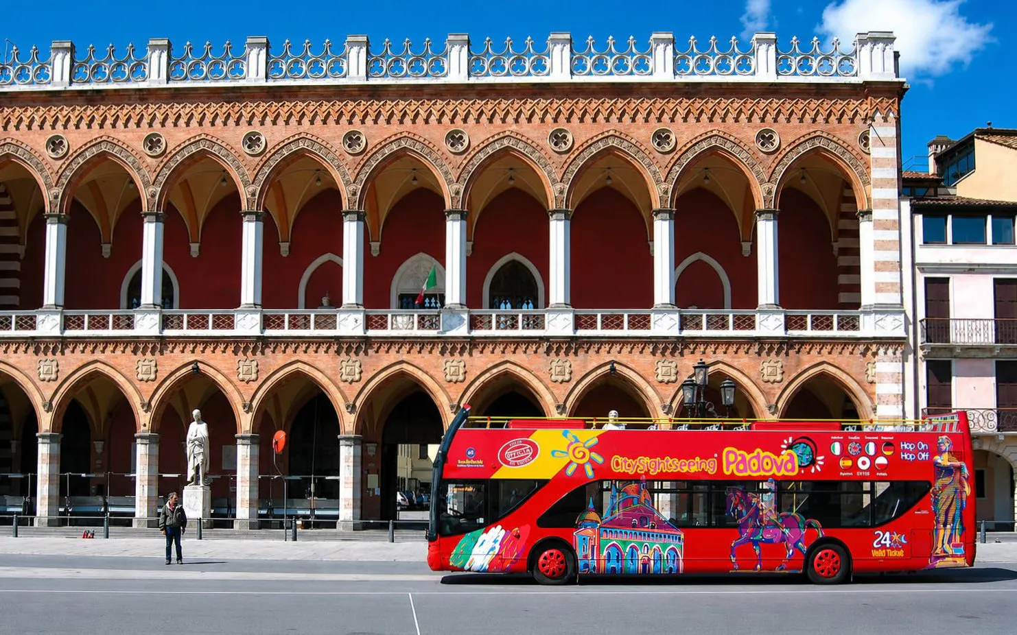 City Sightseeing bus in front of historic building in Padua, Italy.