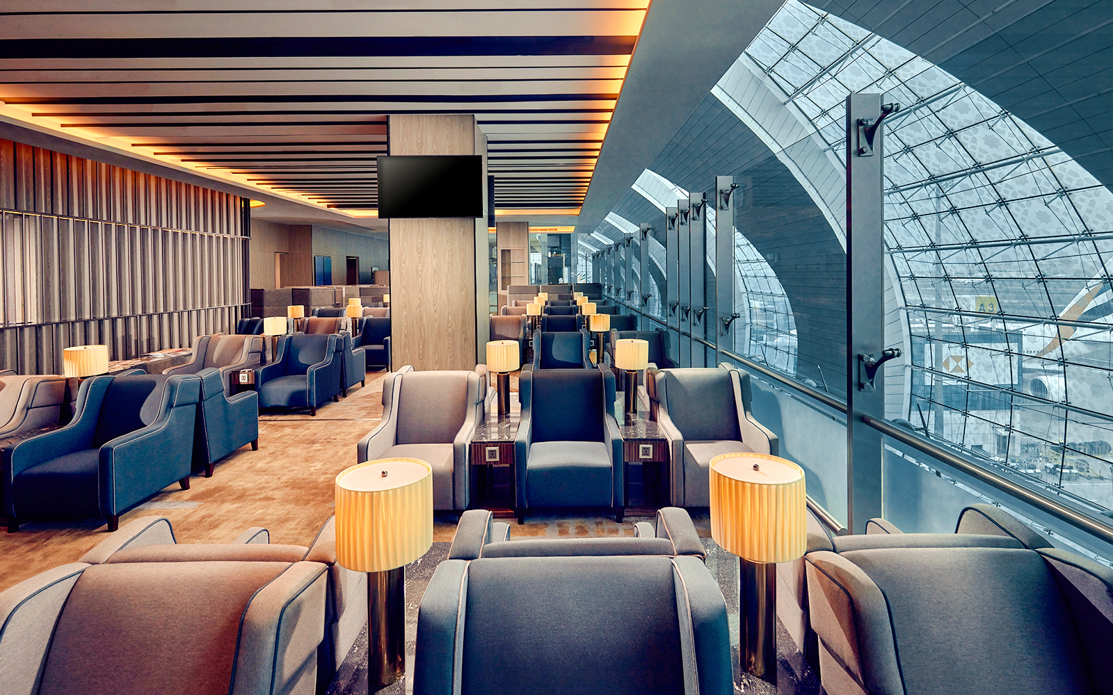 Plaza Premium Lounge seating area at Dubai International Airport with large windows.