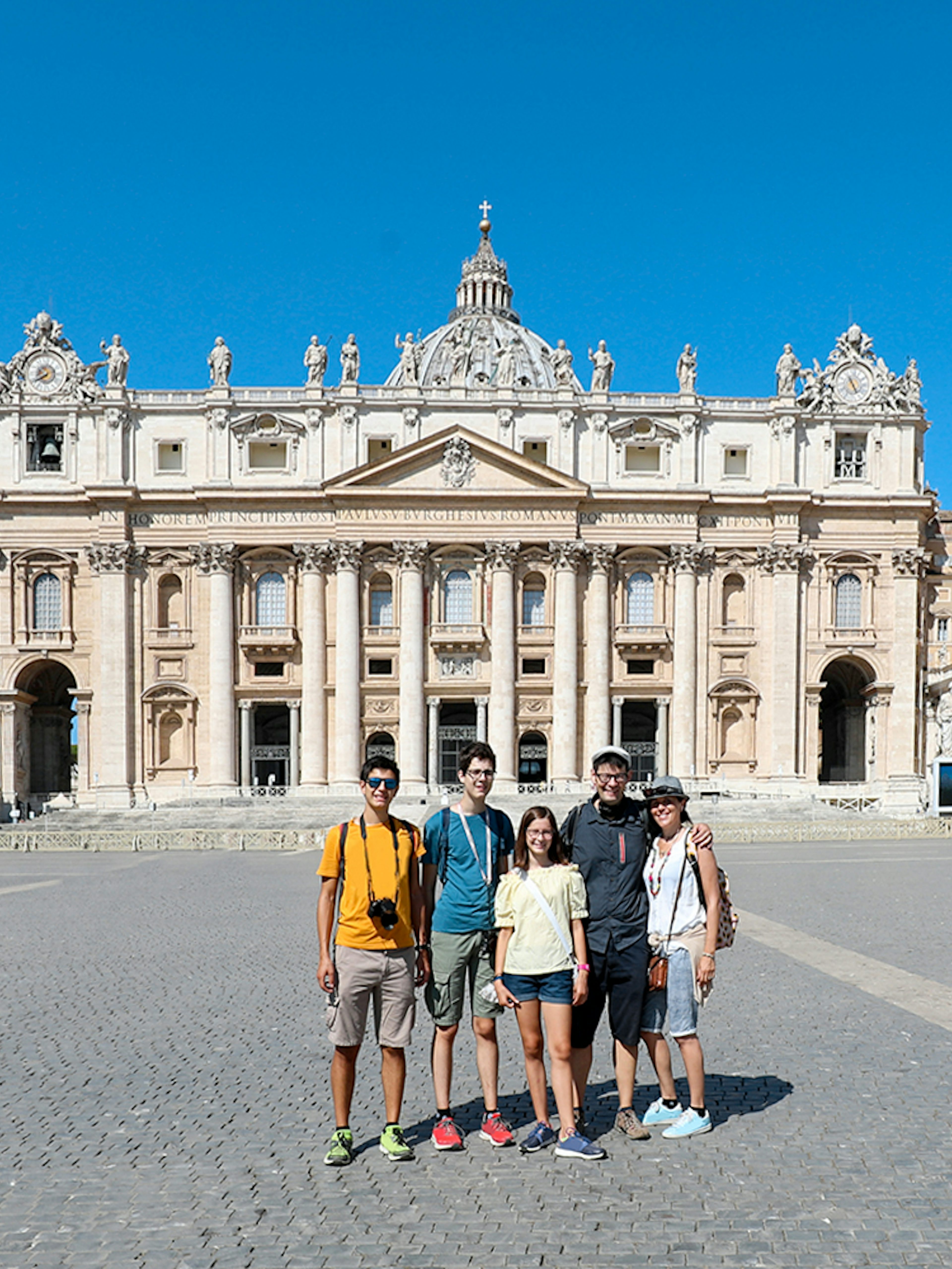 Visitors in front of St. Peter’s Basilica during a guided tour in Vatican City.