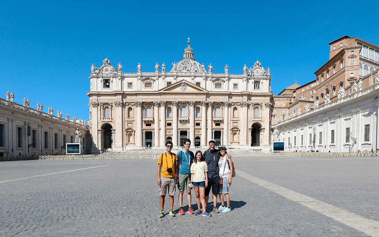 Visitors in front of St. Peter’s Basilica during a guided tour in Vatican City.