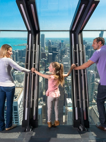 Family enjoying the view from 360 Chicago observation deck.