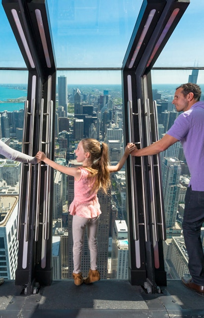Family enjoying the view from 360 Chicago observation deck.