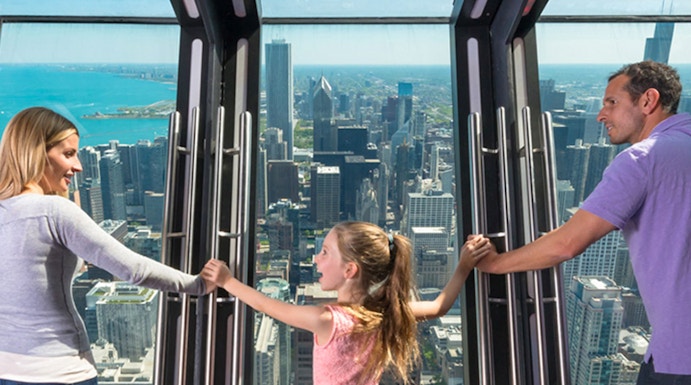Family enjoying the view from 360 Chicago observation deck.