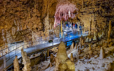 Visitors exploring stalactites and stalagmites in Gyokusendo Cave, Okinawa World.