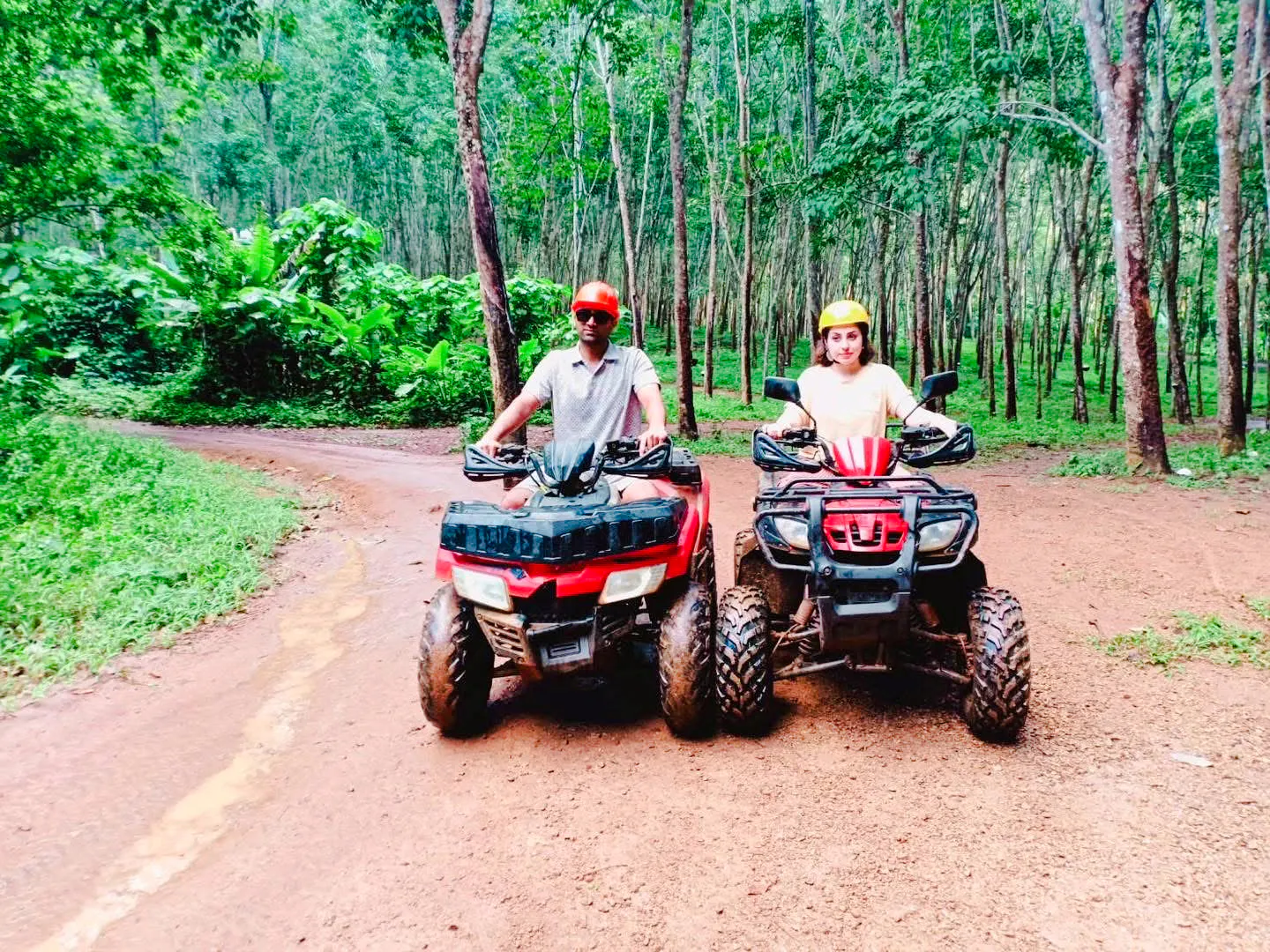 Two people riding ATVs on a forest trail in Ao Thalane, Krabi.