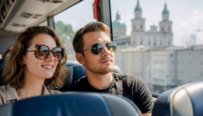 Passengers enjoying views of Salzburg from an AC coach, Austria.