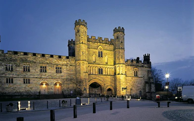 Battle Abbey illuminated at dusk in East Sussex, England.