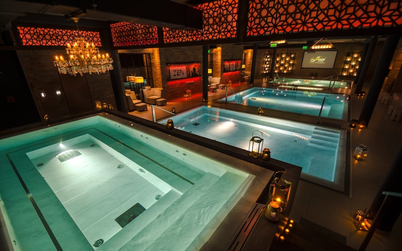 Luxurious indoor pools at Mandala Day Spa with ambient lighting and elegant decor.