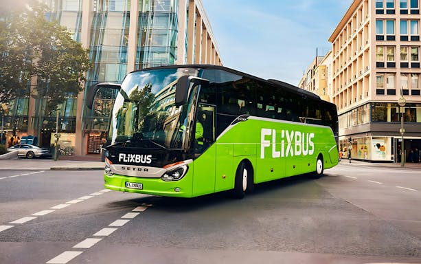 FlixBus in city street, Amsterdam to Efteling route.