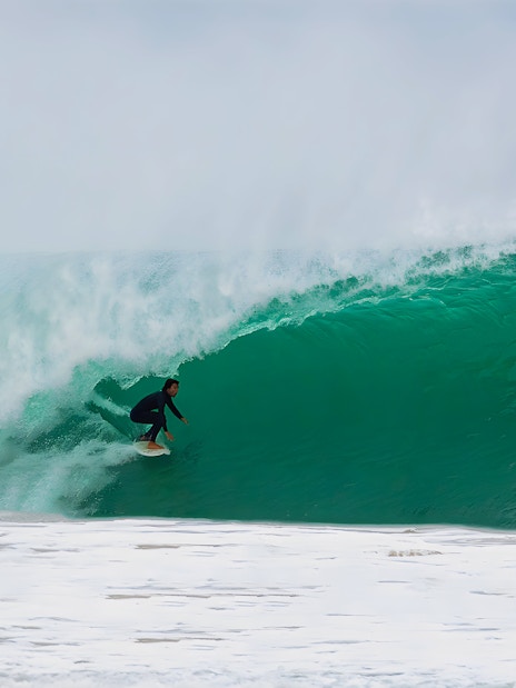 Surfer riding a wave in Lisbon, Portugal.