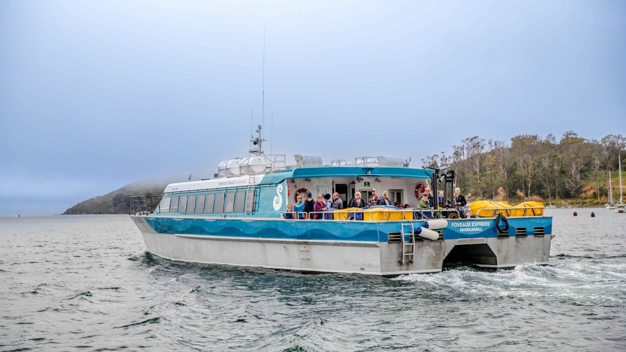 Tourists on the deck of the Stewart Island Ferry in New Zealand waters.